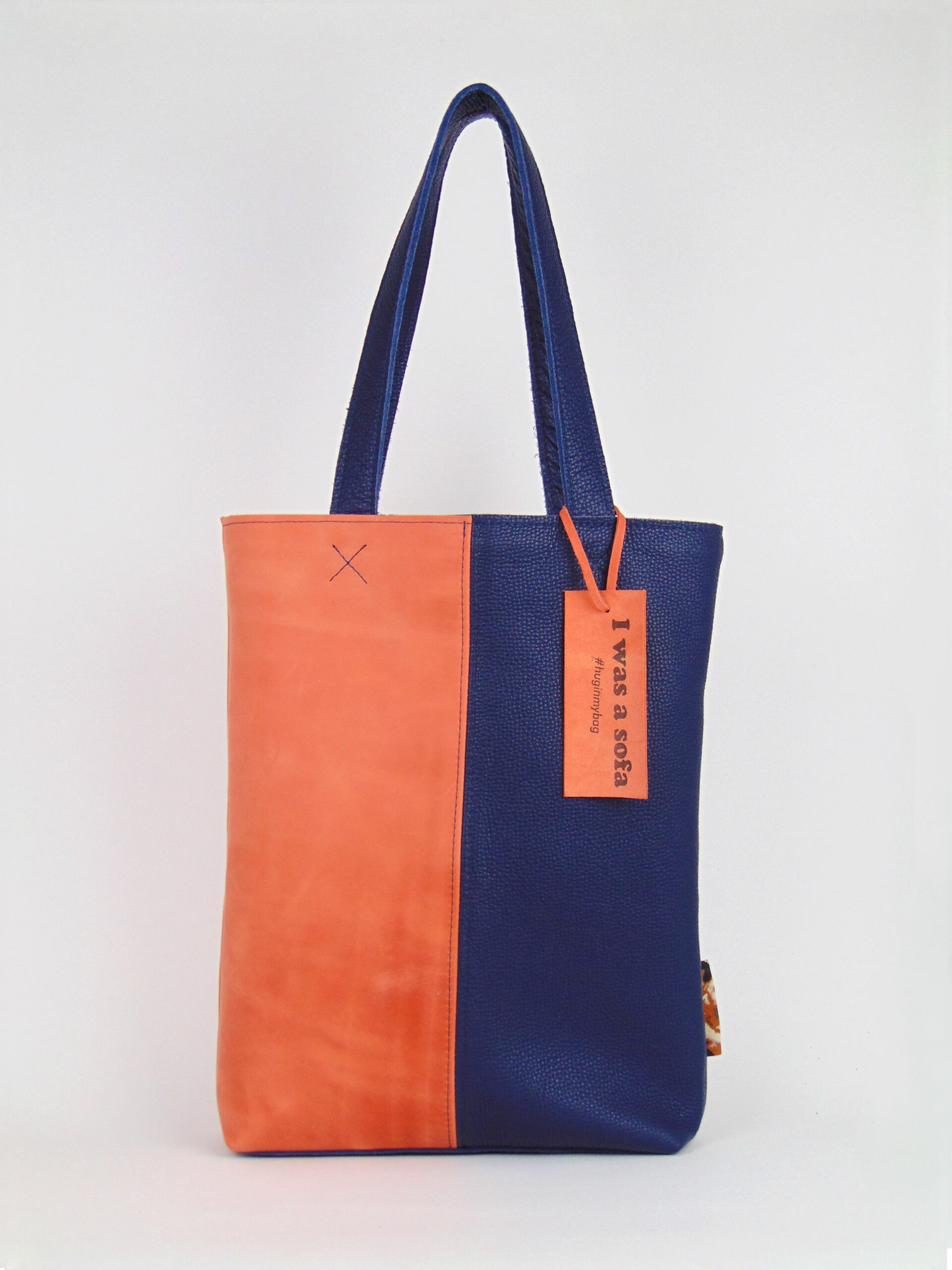 Product image of the shopper named Sporty Blue. This shopper is made from recycled leather in a colour combination of blue and orange.