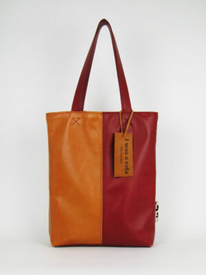 Product image of the shopper named Warm Desert. This shopper is made from recycled leather in a colour combination of red and cognac/orange.