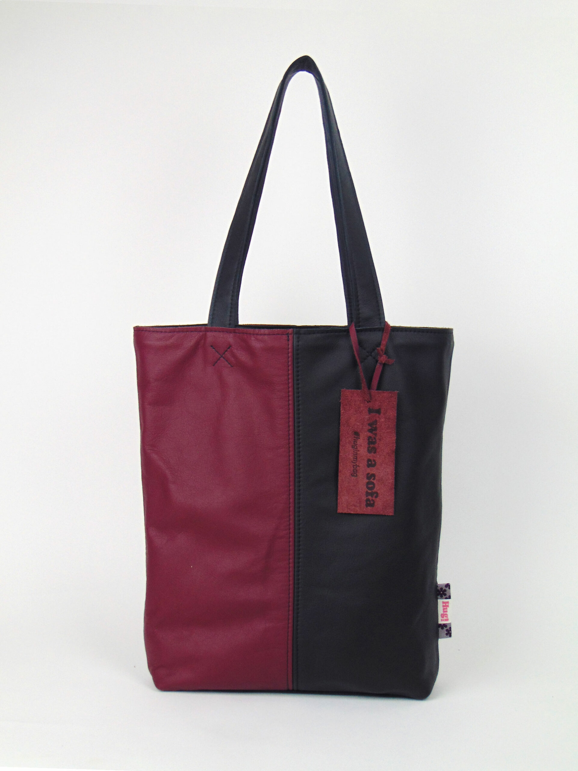 Product image of the shopper named Bubble Gum. This shopper is made from recycled leather in a colour combination of black and red.