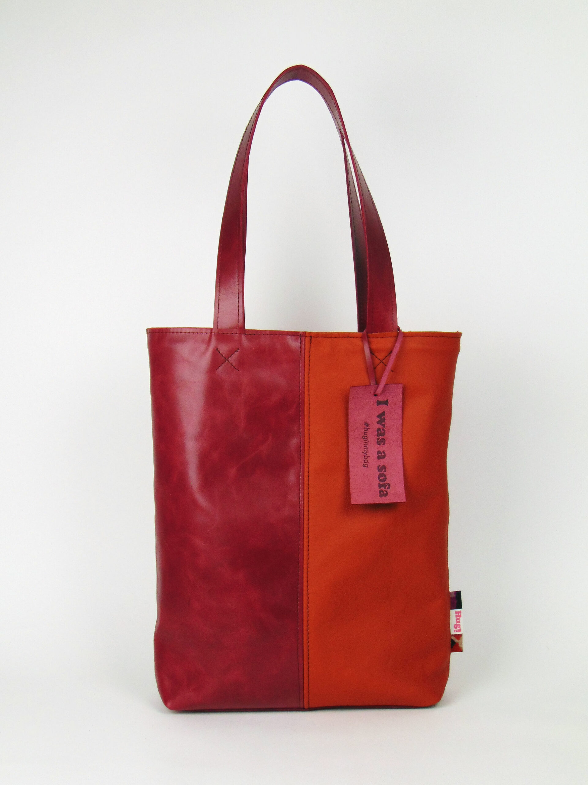 Product image of the shopper named Flower Power. This shopper is made from recycled leather in a colour combination of red and orange.