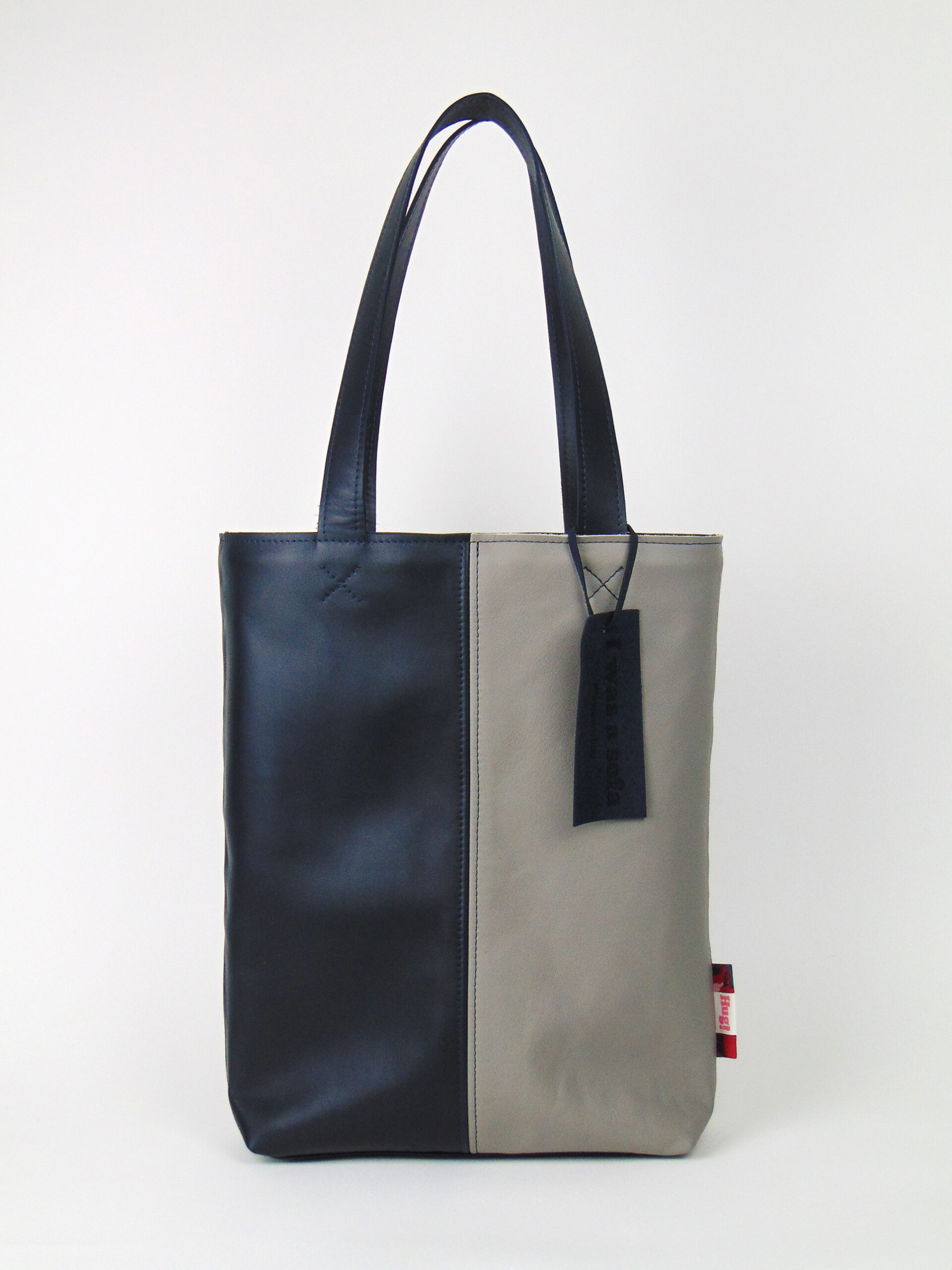 Product image of the shopper named Dust Bunny. This shopper is made from recycled leather in a colour combination of blue and grey.